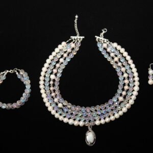 Jewelry set featuring a multi-strand necklace, a bracelet, and drop earrings, each containing pearl and crystal beads - Perles Custom Jewelry NYC